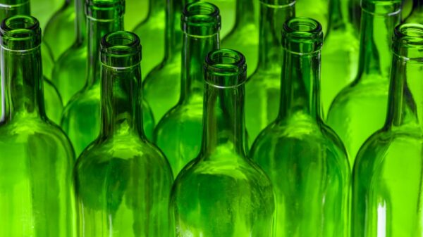 EMPTY WINE BOTTLES STORED IN THE BOTTLING FACTORY. GLASS RECYCLING BEVERAGE INDUSTRY CONCEPT.