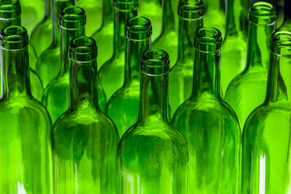 EMPTY WINE BOTTLES STORED IN THE BOTTLING FACTORY. GLASS RECYCLING BEVERAGE INDUSTRY CONCEPT.