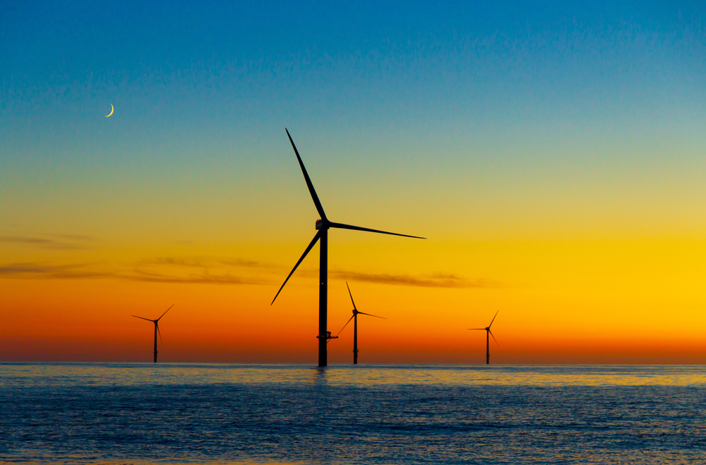 Offshore wind turbines in front of sunset in the North Sea