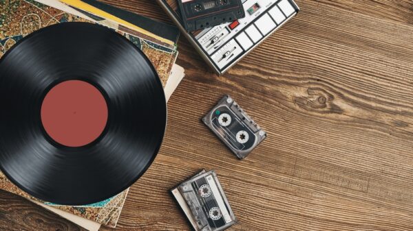Vinyl records, cassette tapes and cassette recorder on wooden table. Retro music style. 80s music party. Vintage style. Analog equipment. Stereo sound. Back to the past The music manufacturer joins companies such as Tilda and L’Occitane Group to receive a B Corp certification.