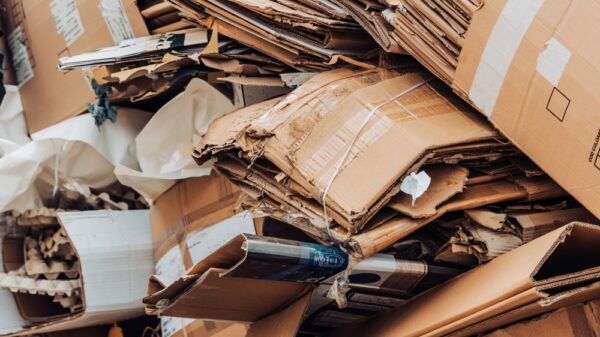 Cardboard waste pile stacked on a landfill. Recycled paper or reuse recycling concept