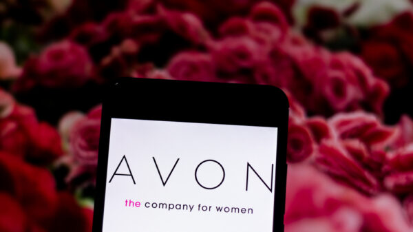 Avon logo on the mobile device screen. Avon is a North American cosmetics company based in New York.
